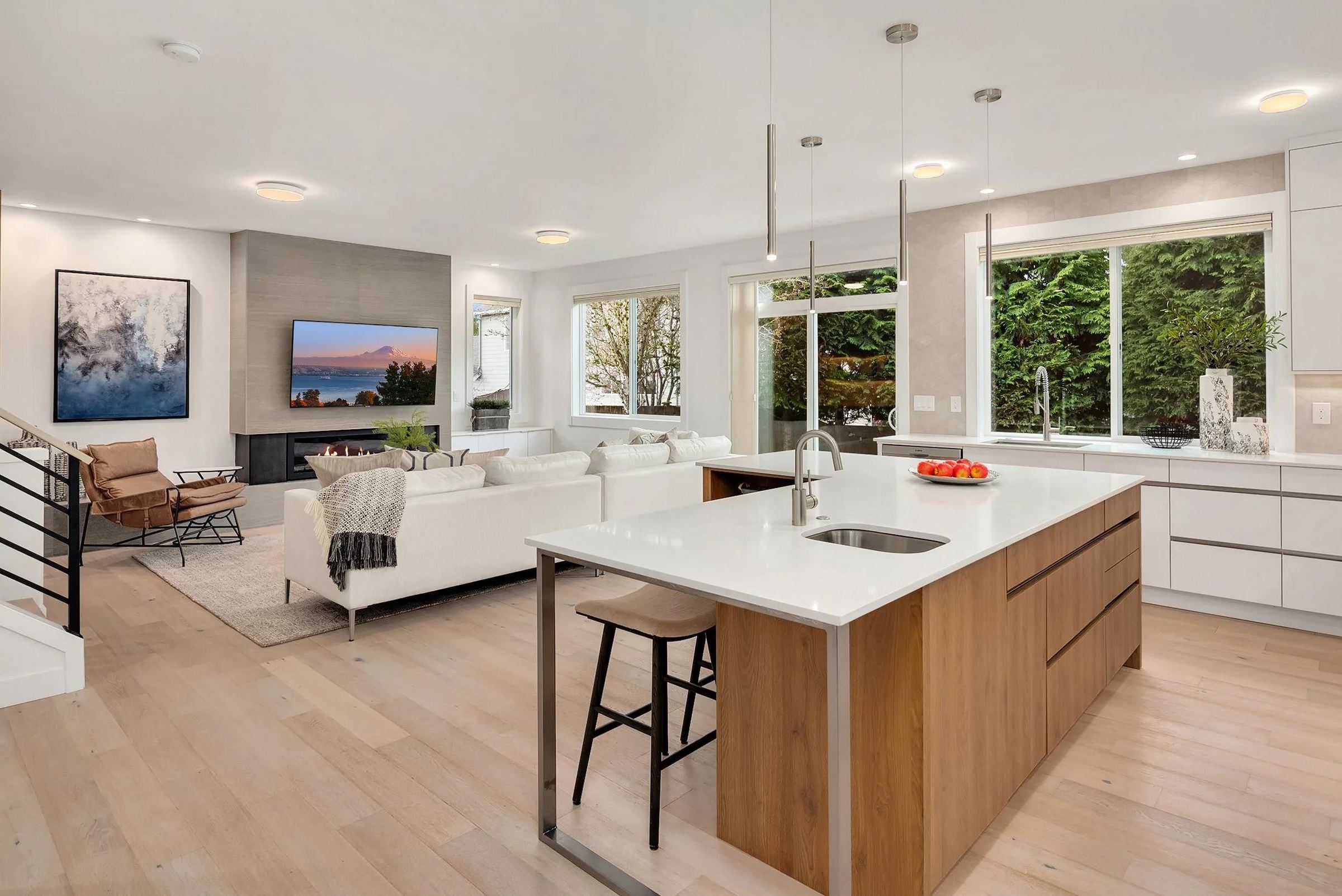 Modern open-plan kitchen and living room in a completed Seattle home remodel